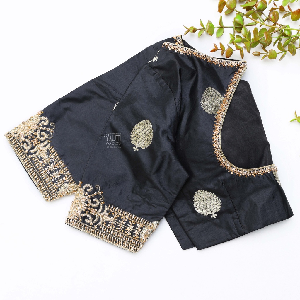 This black silk blouse adorned with intricate gold embroidery