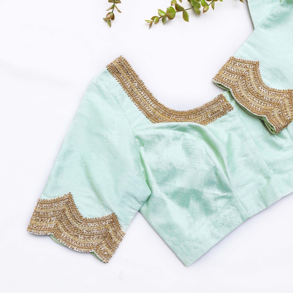 Exquisite craftsmanship meets refreshing hues in this mint green blouse