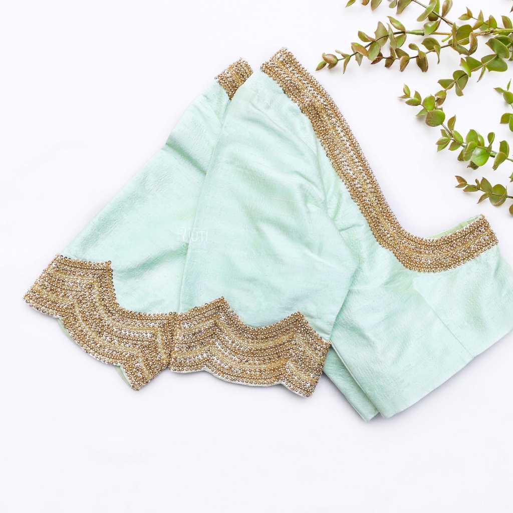 Exquisite craftsmanship meets refreshing hues in this mint green blouse