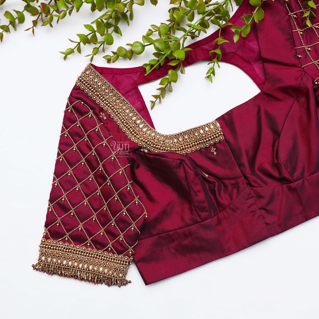 This stunning blouse with gold neck work is stealing the Elegance in maroon