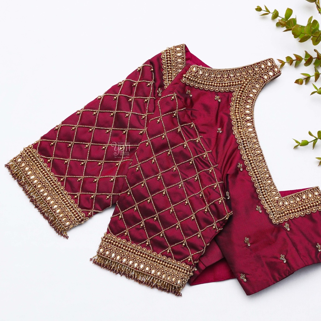 This stunning blouse with gold neck work is stealing the Elegance in maroon