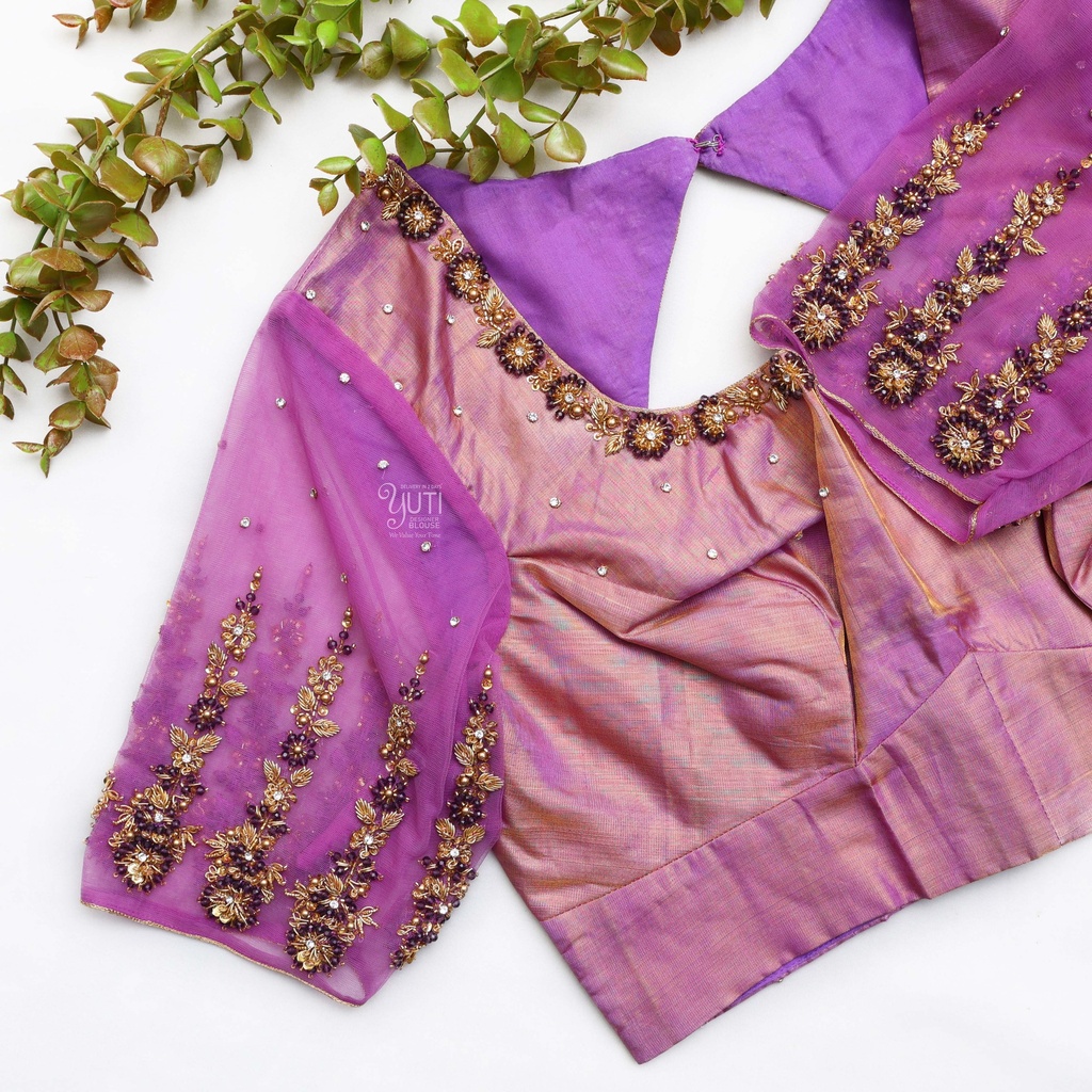 Pink blouse paired with a purple blouse and surrounded by lush greenery