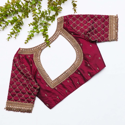 This stunning blouse with gold neck work is stealing the Elegance in maroon